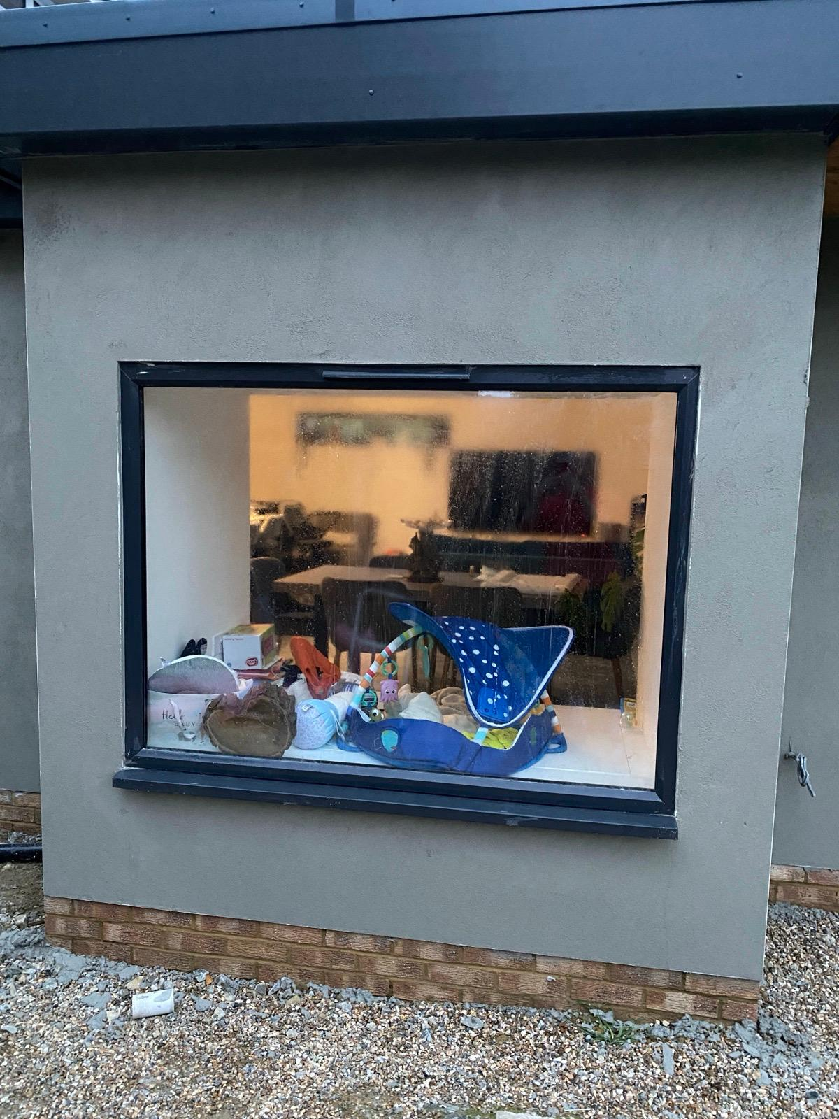 Smooth rendered extension wall surrounding a large window