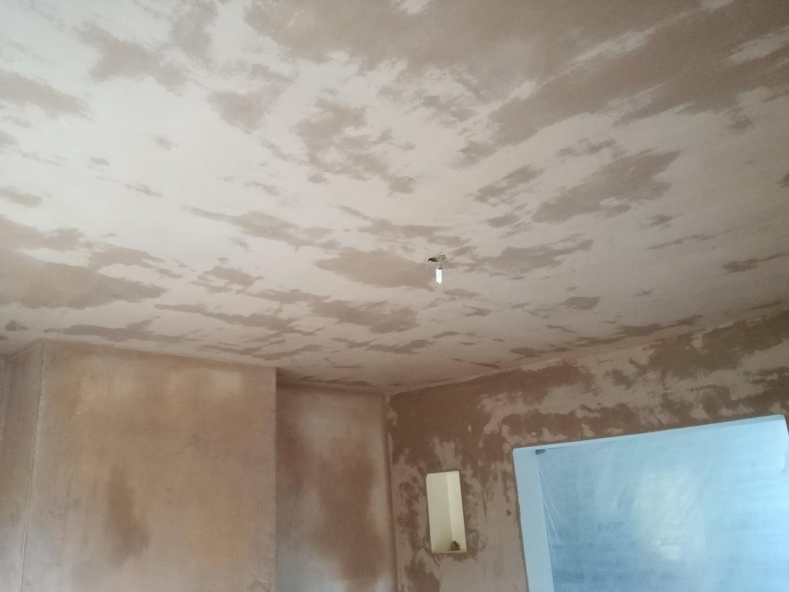 Fresh plaster drying on a broad ceiling and surrounding walls