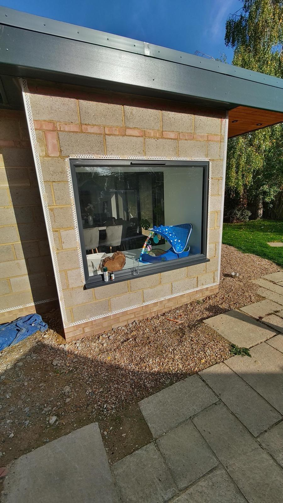 Large exterior window surrounded by blockwork and fitted render beads