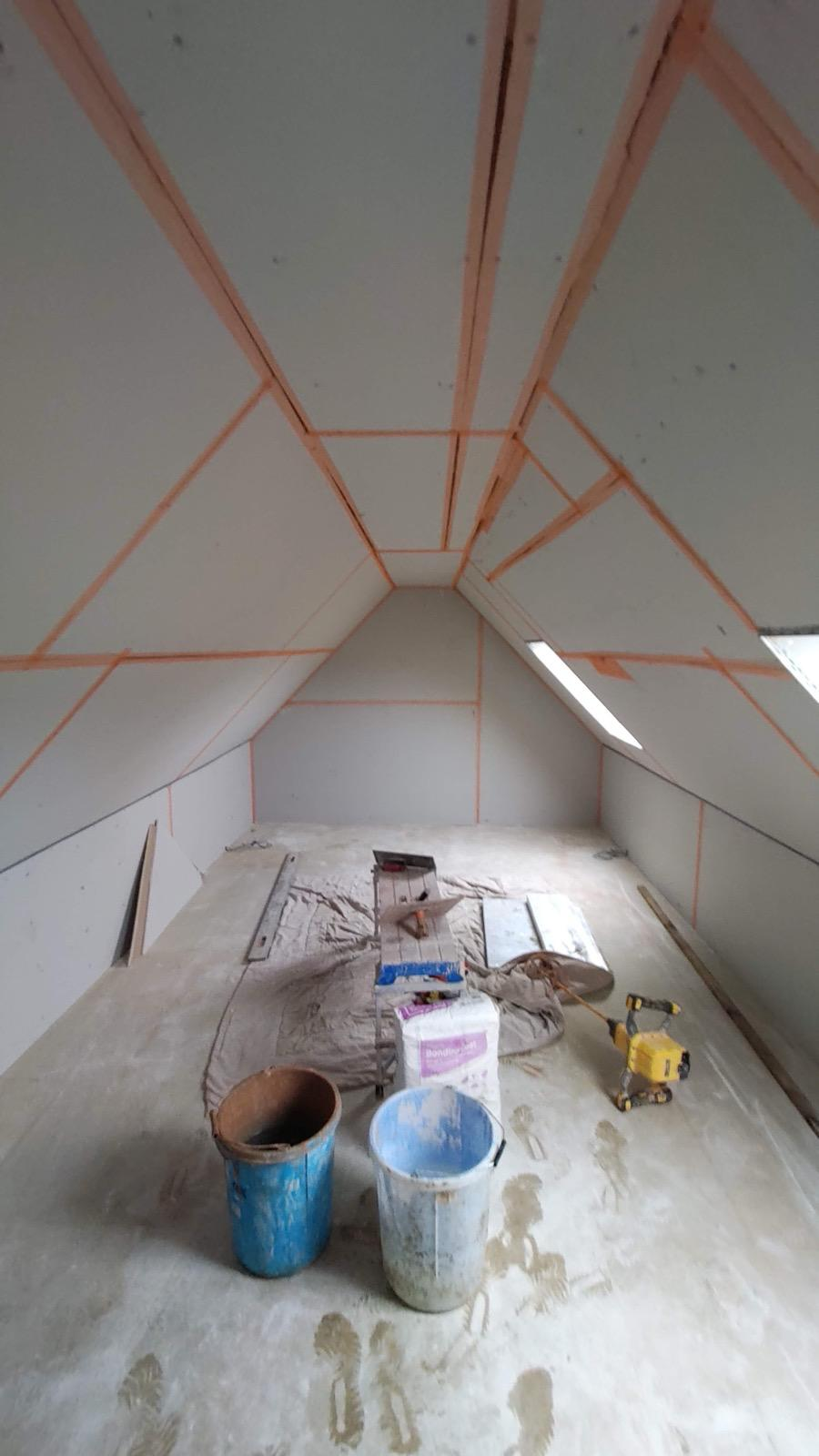 Taped plasterboard loft with mixing buckets and plaster bag