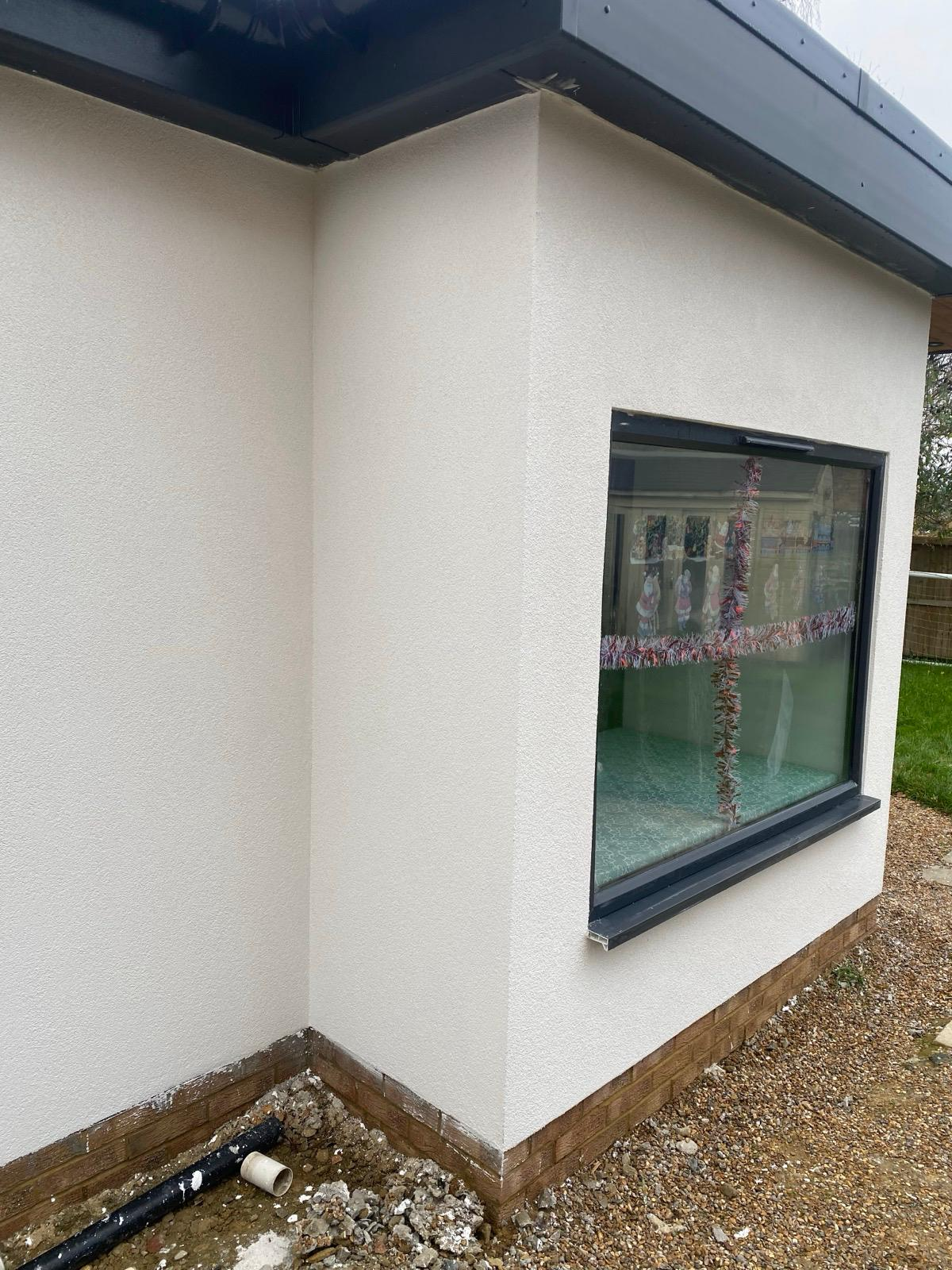 Clean light render finish around a large dark-framed window