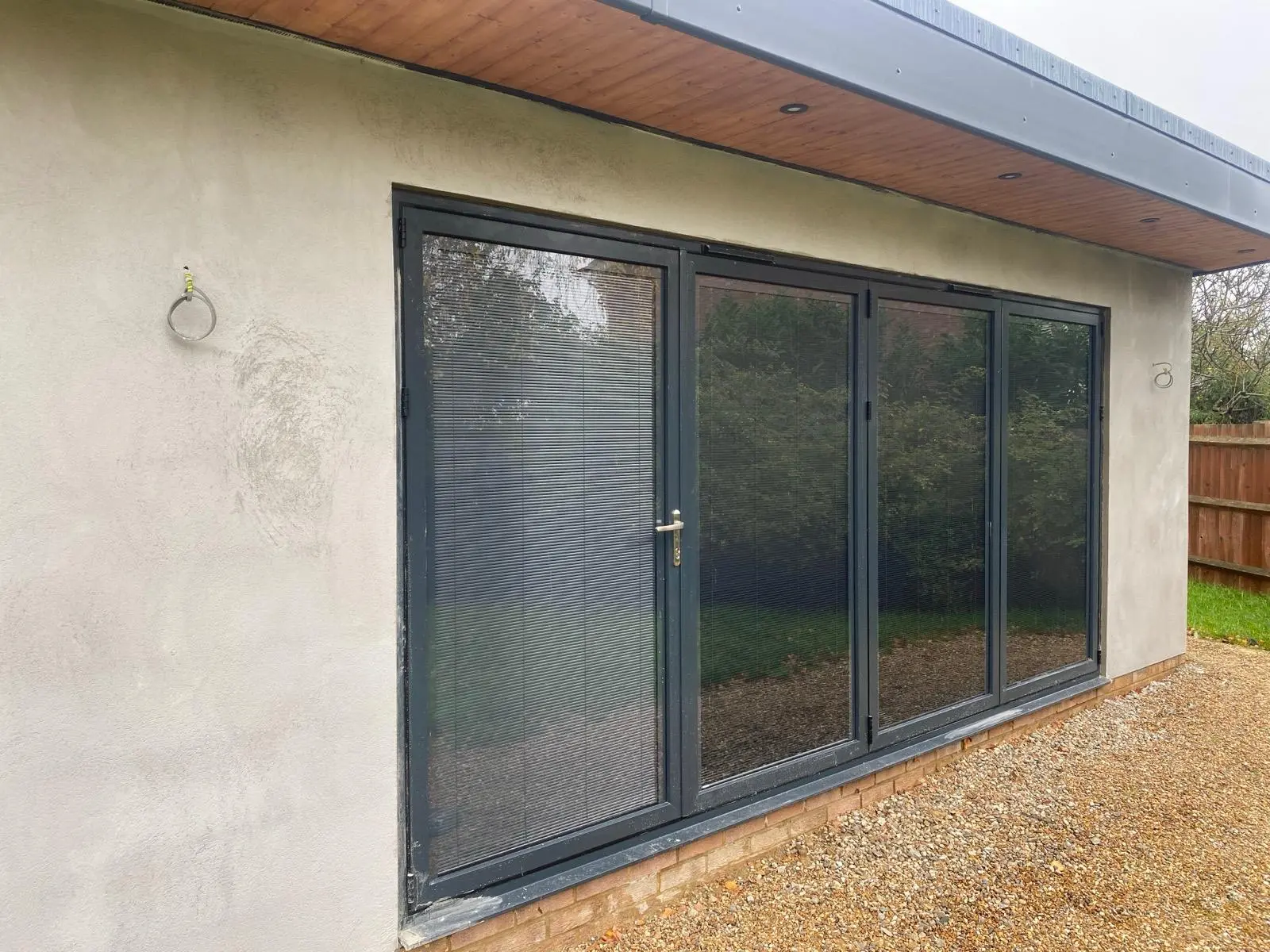 Rendered extension wall framing bi-fold doors
