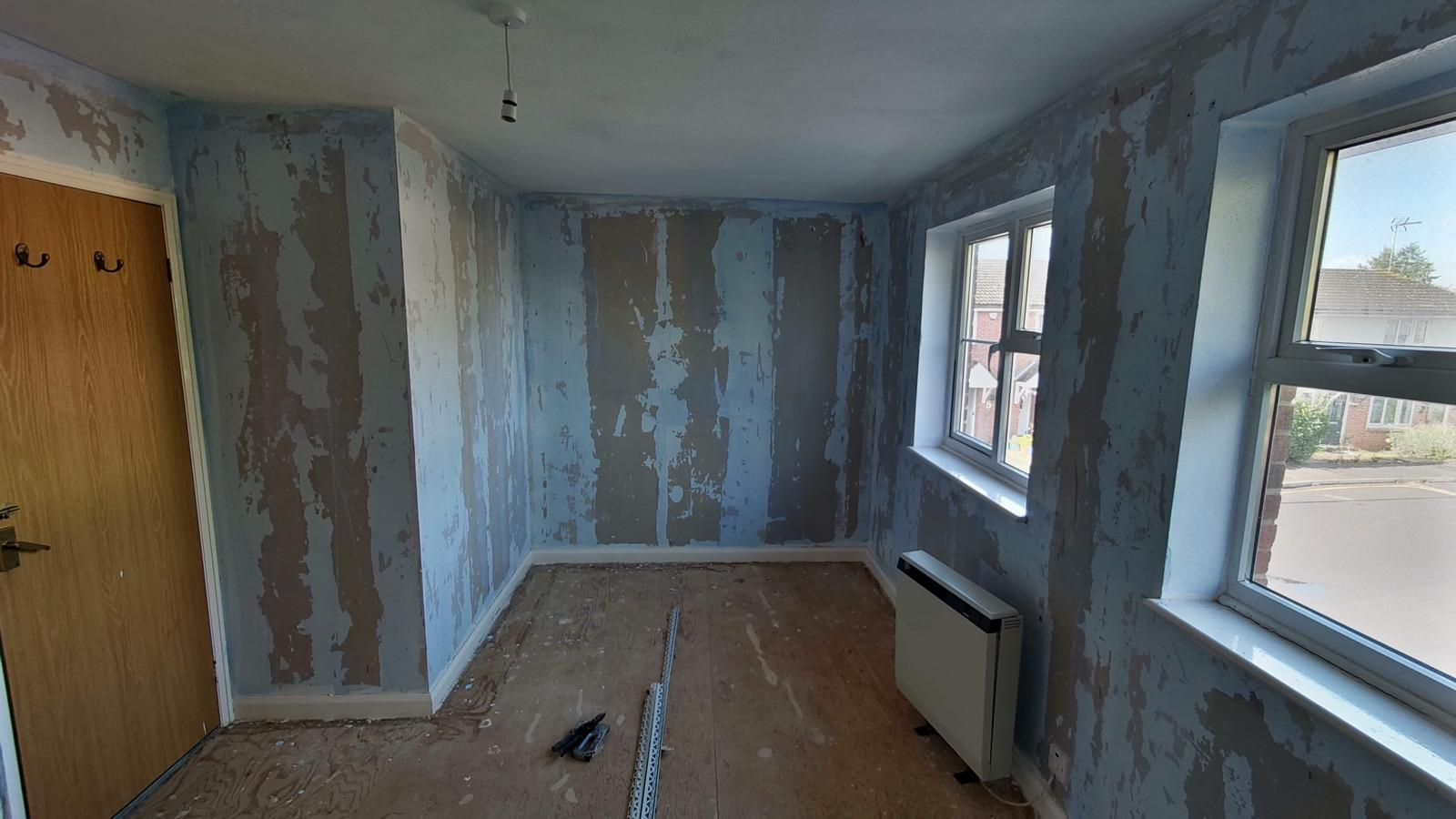 Stripped blue interior walls prepared for a new plaster finish