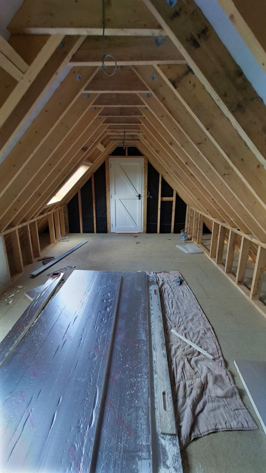 Attic room framework with a roof window and fitted door