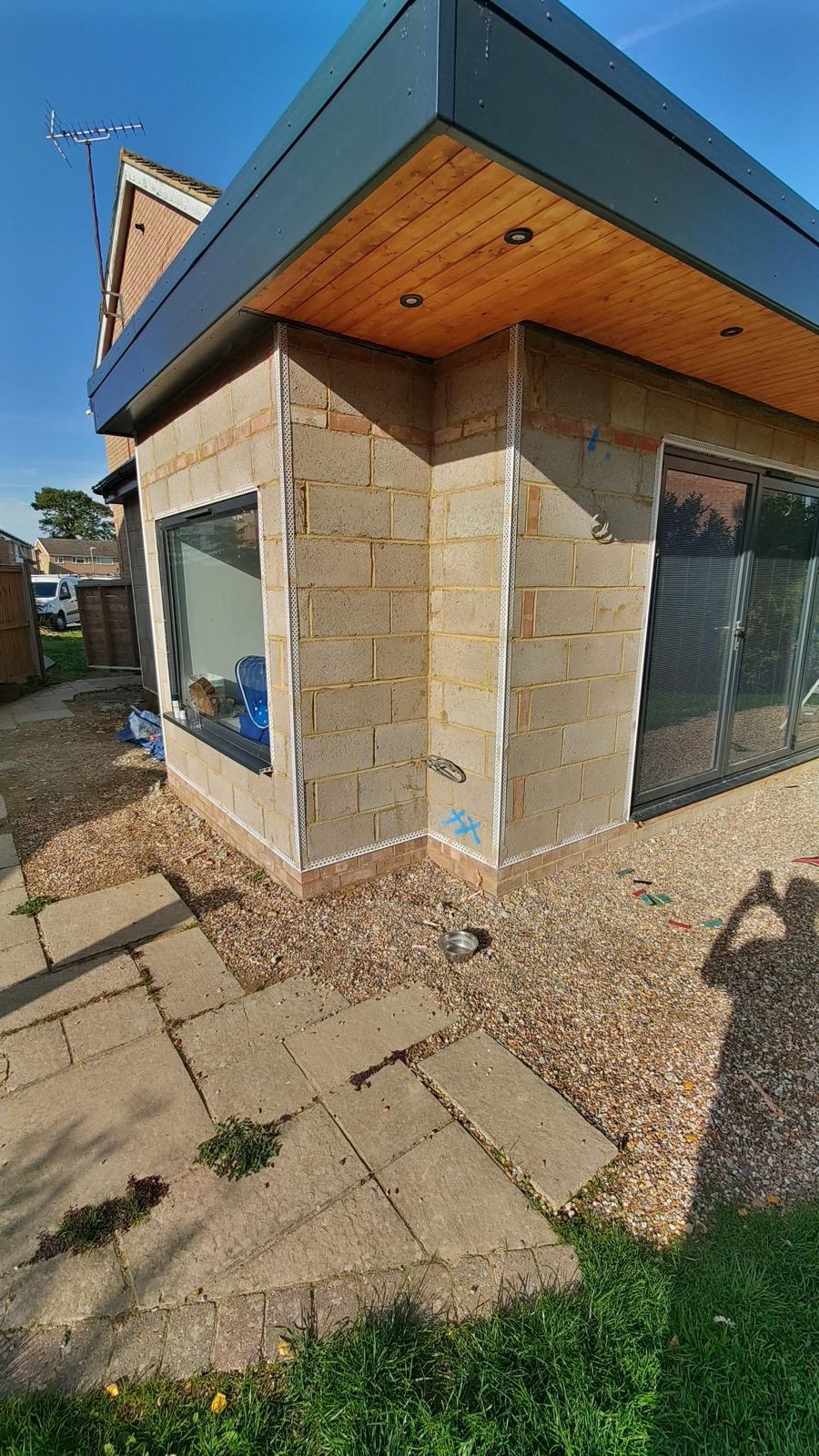 Blockwork extension with corner beads beneath a timber soffit